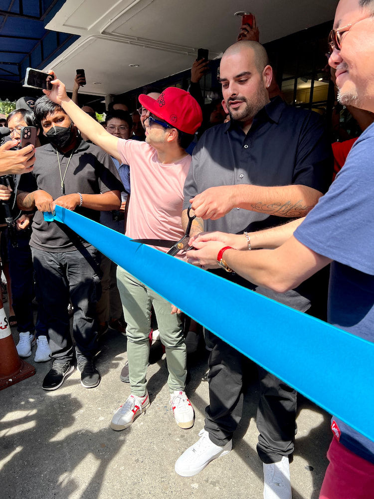 Berner cuts the ribbon at the Cookies Bangkok with his Thai partner Joe Thawilvejjakul of Great Earth International during the store opening ceremonies on January 21, 2023.